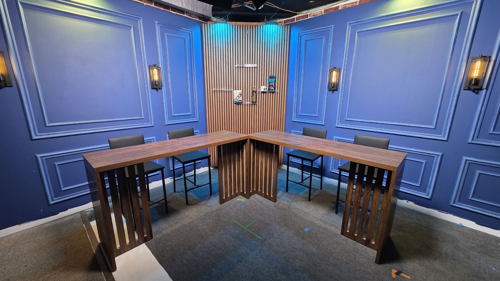 The Founders Den set: classic paneled walls and wood desks